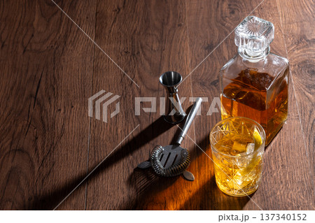 Rusty Nail Cocktail with Lemon Peel in Crystal Glass 137340152