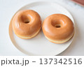 Two Glazed Donuts on White Plate Close-Up 137342516