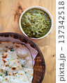 Delicious Indian Palak Paneer Curry with Garlic Naan Bread on Wooden Table 137342518