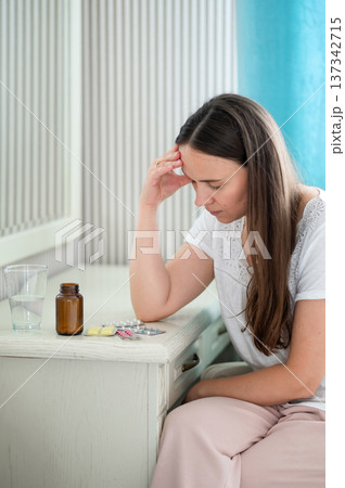 A young woman eats strawberries in the kitchen 137342715