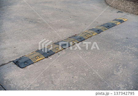 Rubber Speed Bump on Concrete Surface 137342795