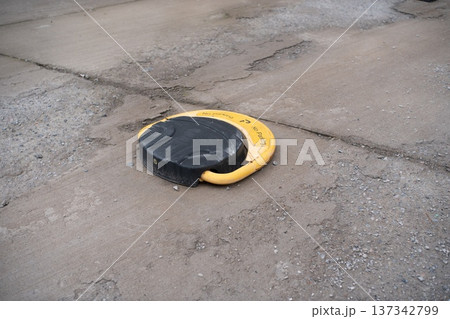 Parking Disk on Cracked Concrete Surface 137342799