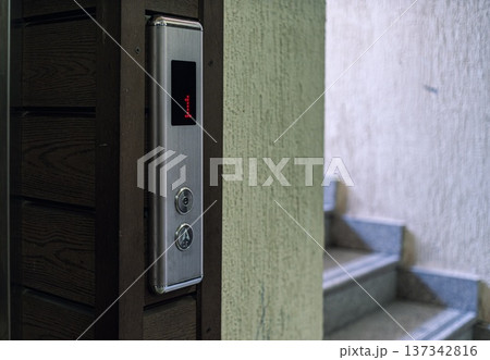 Elevator Control Panel with Stairs in the Background 137342816