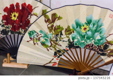 Painted traditional folding fans with floral design 137343216