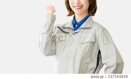 ガッツポーズをする作業服の女性 ガッツポーズをする作業服の女性 137343639