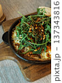 Baked eggs with arugula greens 137343816