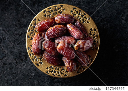 Dates fruits on black stone table. 137344865