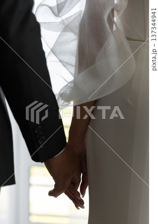 Groom and bride holding hands during wedding ceremony Groom and bride holding hands during wedding ceremony 137344941