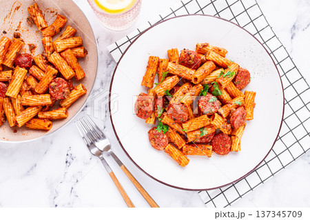 rigatoni pasta with spicy sausage, and rich tomato sauce served, on a white plate, homemade, rigatoni pasta with spicy sausage, and rich tomato sauce served, on a white plate, homemade, 137345709
