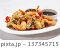 Shrimp and vegetable tempura, served with dipping sauce, on a white plate 137345715