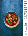 seafood in tomato sauce with olives, on a dark blue background, 137345716