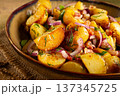 German potato salad with bacon, onions and herbs, plate on a wooden table, rustic style, no people, 137345725
