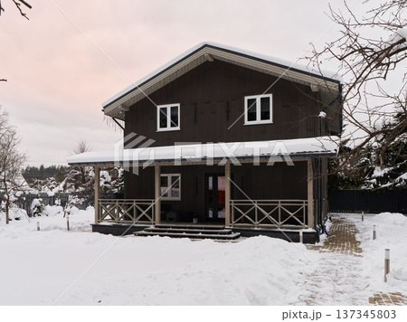 Warm reception at snowcovered cabin with inviting ambiance Warm reception at snowcovered cabin with inviting ambiance 137345803