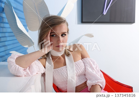 Entrepreneur leaning in red chair minimalist studio Entrepreneur leaning in red chair minimalist studio 137345816