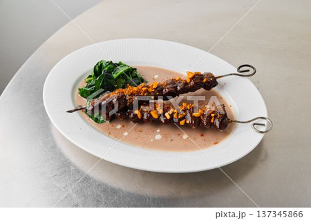 Modern comfort dining, Creamy glazed skewers served with greens Modern comfort dining, Creamy glazed skewers served with greens 137345866