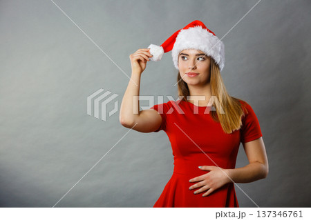 Positive woman wearing Santa Claus helper costume 137346761