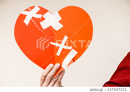 Male hand holding broken heart Male hand holding broken heart 137347131