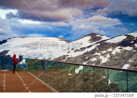 Tourist with camera on tripod in Norway nature Tourist with camera on tripod in Norway nature 137347169