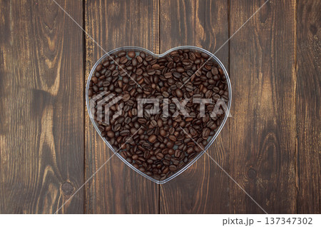 Heart made of coffee beans on wooden background, top view, copyspace. Cafe menu design concept 137347302