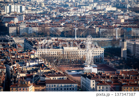 Lyon, france. December 27, 2023. Lyon city panorama featuring place bellecour with its ferris wheel, saone river, and historic architecture under sunny skies Lyon, france. December 27, 2023. Lyon city panorama featuring place bellecour with its ferris wheel, saone river, and historic architecture under sunny skies 137347387