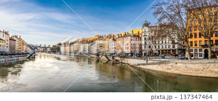 Lyon, France. December 27,2023. Wide format panoramic shot of the city with traditional buildings lining the Saone River, reflecting France's historic architecture under a clear sky. Lyon, France. December 27,2023. Wide format panoramic shot of the city with traditional buildings lining the Saone River, reflecting France's historic architecture under a clear sky. 137347464