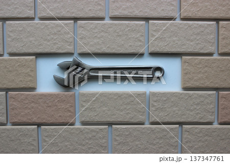 Adjustable Wrench In Compartment Inside Tiles Brickwork Top View. Stock Photo For DIY Repair Illustration  137347761