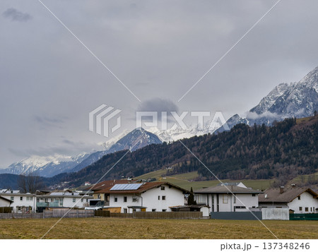 Idyllic Rural Community Situated Beside Majestic Snowy Summits And Lush Fields 137348246