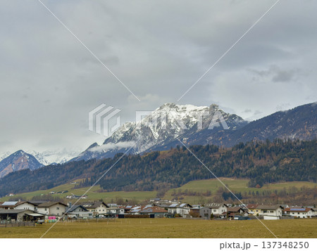 Serene Mountain Hamlet Surrounded By Snowy Summits And Lush Trees Serene Mountain Hamlet Surrounded By Snowy Summits And Lush Trees 137348250