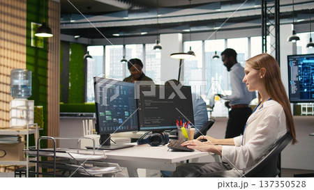 Pleased supervisor recognizing junior dev achievements at work, fostering positive office culture. Cheerful african american manager praising code written by female engineer, doing high five, camera A 137350528