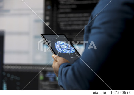 In a futuristic digital workspace, black developer programming software and explores code snippets. Tech professional embodies innovation, cybersecurity, automation and development. 137350658