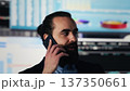 Modern leader on a phone line call discusses fintech and technology strategy. Using business data, visualization tools and forecasting models to drive investment performance. Camera A. 137350661