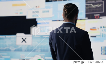 Unstoppable entrepreneur being confident with his successful business, looking around at fruitful performance metrics and insight. Feeling pride about corporate legacy, empowerment. Camera A. 137350664