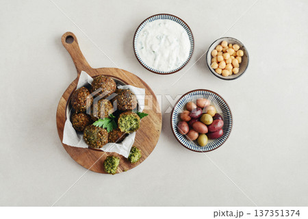 A bowl of crispy golden brown falafel balls with tahini sauce A bowl of crispy golden brown falafel balls with tahini sauce 137351374
