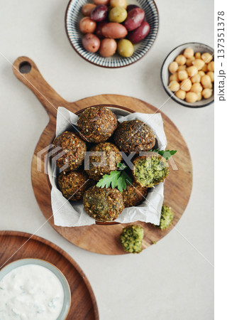 A bowl of crispy golden brown falafel balls with tahini sauce A bowl of crispy golden brown falafel balls with tahini sauce 137351378