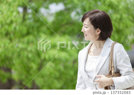 公園を歩くキャリアウーマン 137352083