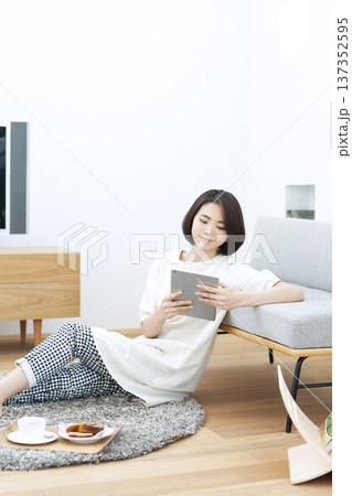 リビングでタブレットを操作する女性 137352595