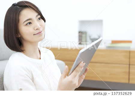 リビングでタブレットを操作する女性 137352629