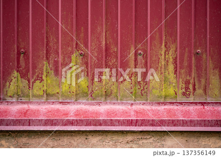 Corrugated metal wall revealing weathered texture with moss and rust patterns Corrugated metal wall revealing weathered texture with moss and rust patterns 137356149