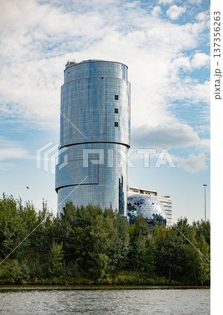 Reflection Tower skyscraper rising above river, blending modern architecture with nature Reflection Tower skyscraper rising above river, blending modern architecture with nature 137356263