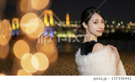 夜景のお台場を背景に黒いドレスを纏う日本人女性 137356442