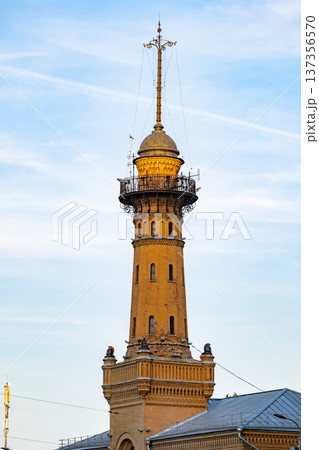 Historic brick building fire tower against a clear blue sky in Moscow. Historic brick building fire tower against a clear blue sky in Moscow. 137356570
