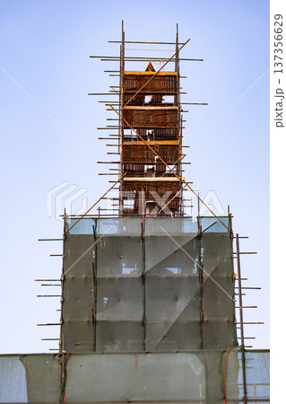 Scaffolding structure covering a building tower during a modernization project 137356629