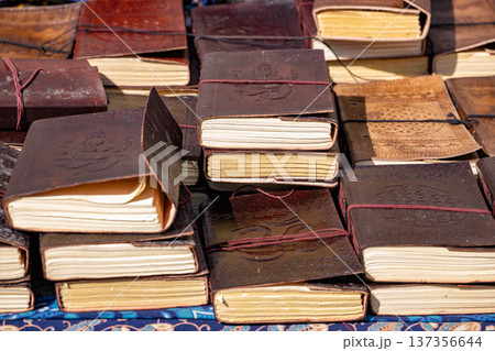 Handcrafted leather journals and diaries with embossed designs, piled for sale Handcrafted leather journals and diaries with embossed designs, piled for sale 137356644