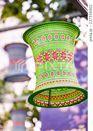 Colorful green textile lantern hanging outdoors, celebrating culture and tradition 137356802