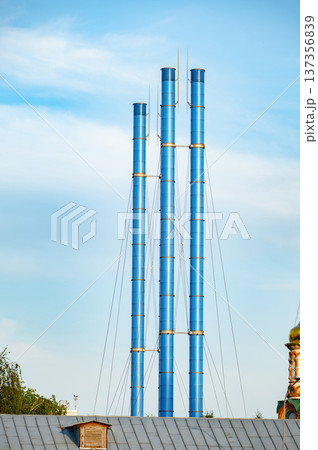 Three blue exhaust pipes of GES-2 power plant contrasting traditional architecture in Moscow 137356839