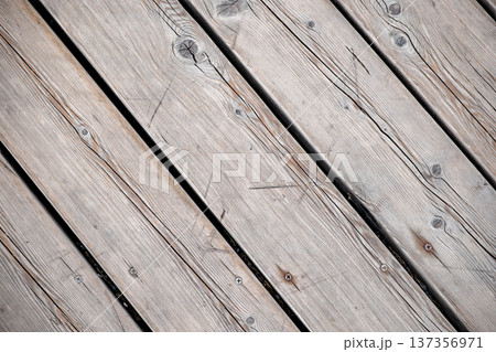 Weathered wooden planks forming abstract diagonal pattern texture with natural grain Weathered wooden planks forming abstract diagonal pattern texture with natural grain 137356971