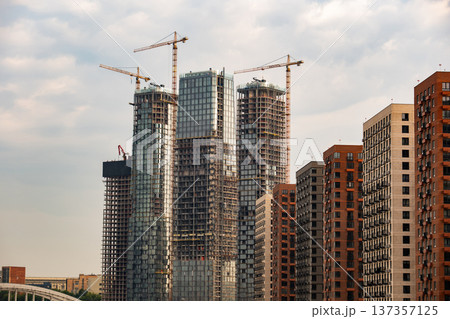City skyline with new skyscrapers constructing next to modern residential buildings City skyline with new skyscrapers constructing next to modern residential buildings 137357125