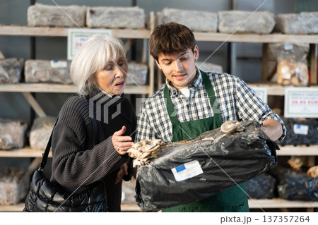Older woman choosing mycelium in a garden store Older woman choosing mycelium in a garden store 137357264