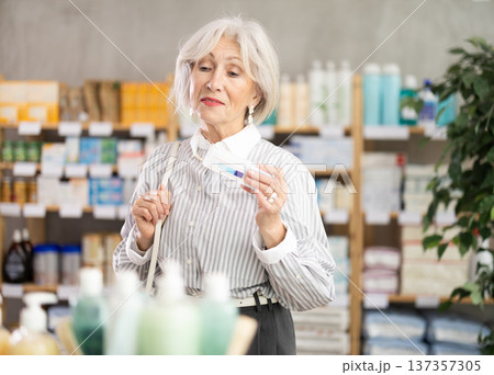 pensioner chooses an ointment for joints pensioner chooses an ointment for joints 137357305