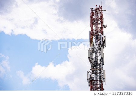 Telecommunication tower providing cellular and mobile signal coverage against a cloudy sky Telecommunication tower providing cellular and mobile signal coverage against a cloudy sky 137357336